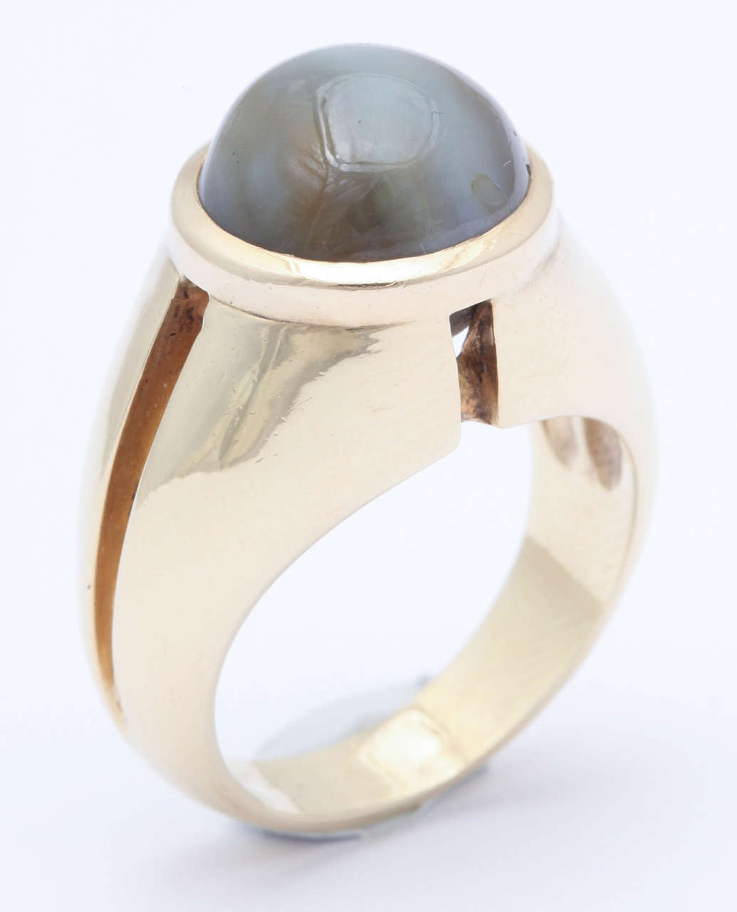 A rare and stunning large size men's ring set with a very striking chrysoberyl cats-eye, that these photographs do not do justice to.  The stone exhibits a beautiful streak of silky light passing through the center, and a wonderful overall colour.