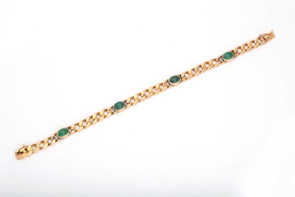 18Kt Yellow Gold flat curb chain bezel set with 4 Cabochon Emeralds.