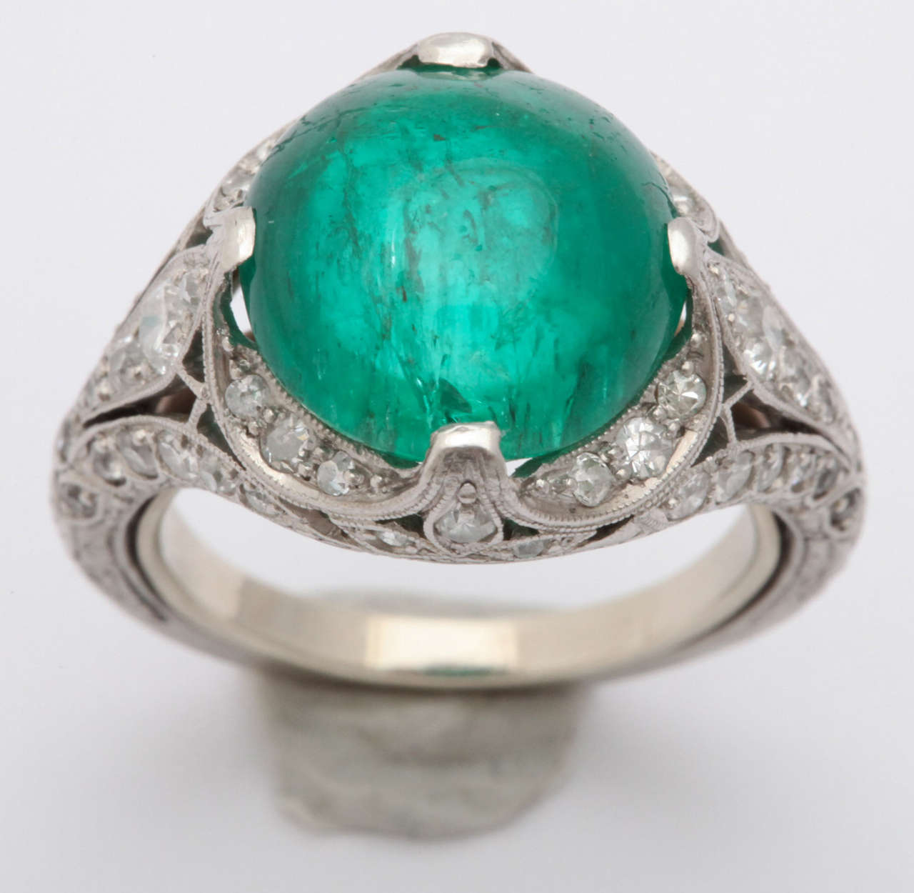 Magnificent round cabochon Columbian Emerald approximate weight 5.00 carats.  intricate micro pave around filagree  setting 50 diamonds approximate weight 2.50 carats