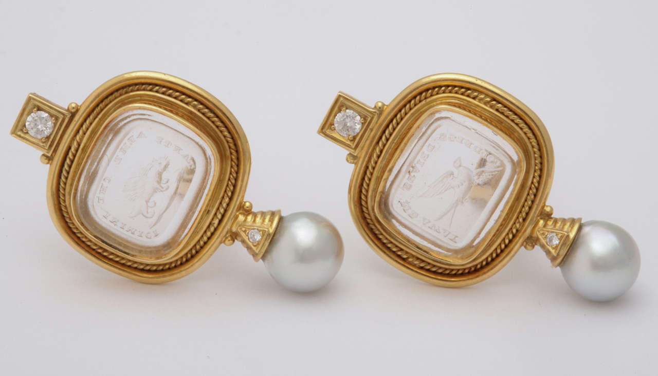 18k yellow gold mounts centering an antique rock crystal reverse engraved crest. cultured pearl and 2 diamonds 0.15 each