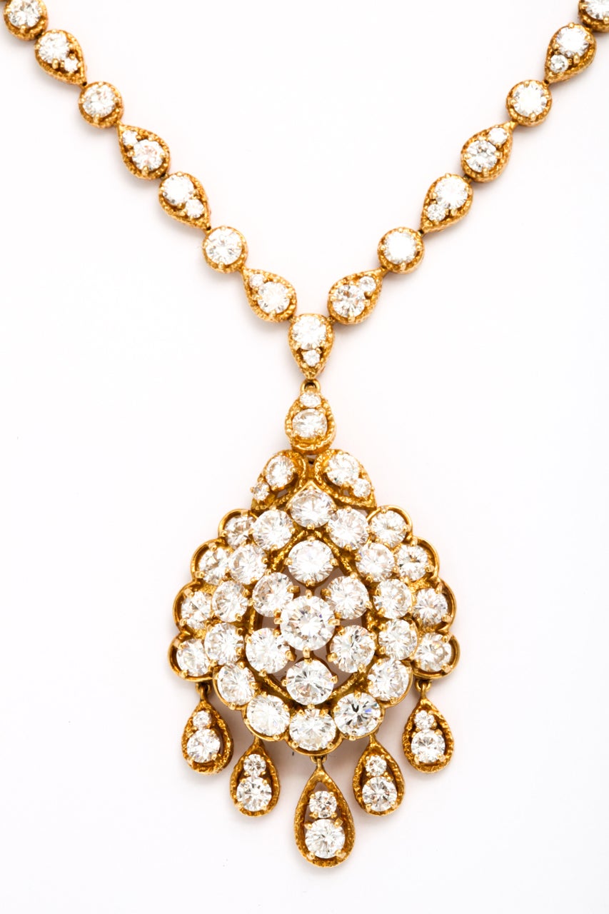 Comprising a necklace, suspending a detachable circular-cut diamond cluster pendant, to the circular-cut diamond necklace chain; and a pair of ear clips en suite, mounted in 18k gold, 18ct diamonds approx., necklace 17ins., 33ct diamonds approx.,