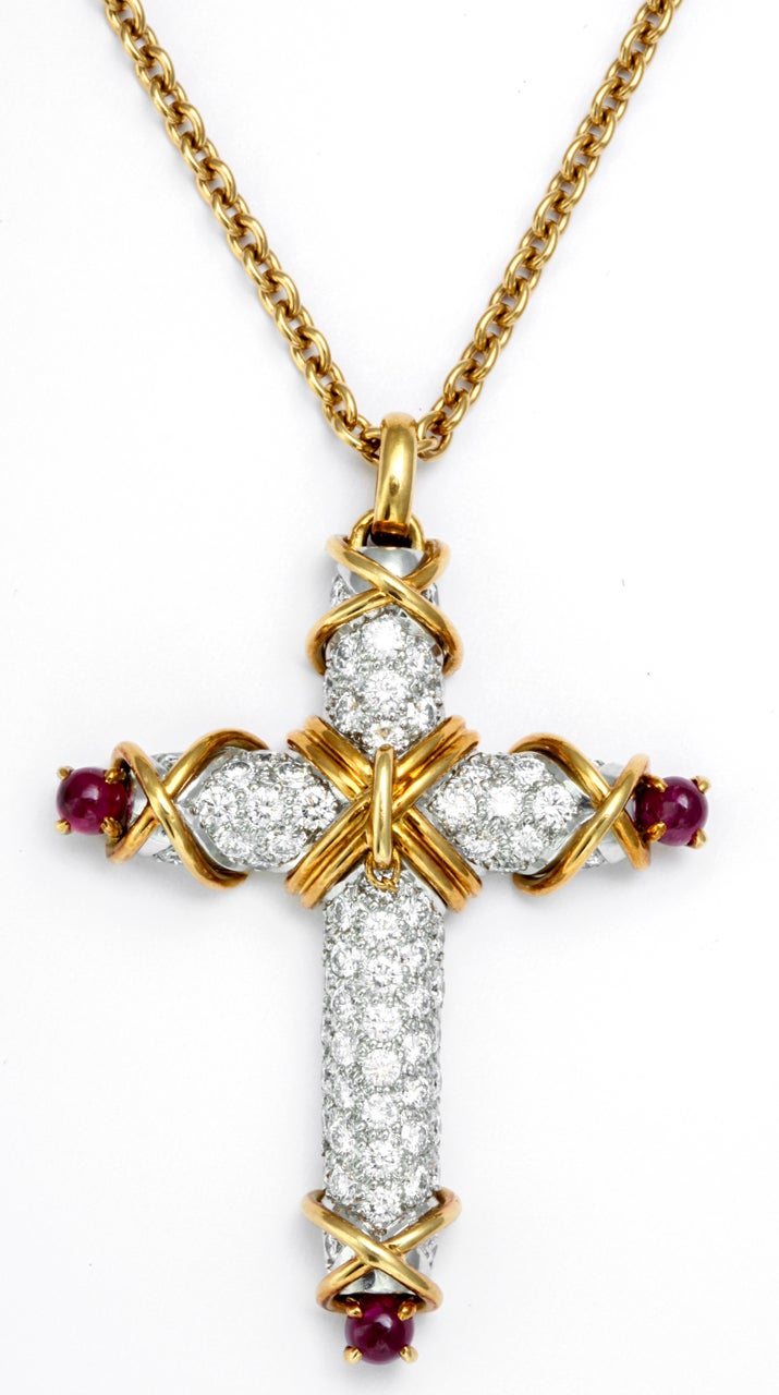 TIFFANY & CO. JEAN SCHLUMBERGER Diamond Ruby Cross Chain Necklace. Platinum and 18K yellow gold cross pendant with diamond pave, approx. 3.4 cts. TW., and ruby cabochons, approx. 1 ct. TW. Length - 2 1/8