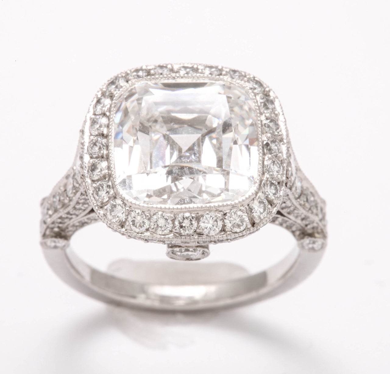 A breathtaking cushion cut ring with center diamond weighing 5.56 carats and surrounding 1.30 carats of round brilliant diamonds.The diamonds are E color and VS2 clarity. This exquisite piece is sign Tiffany & Co., the mounting is called the