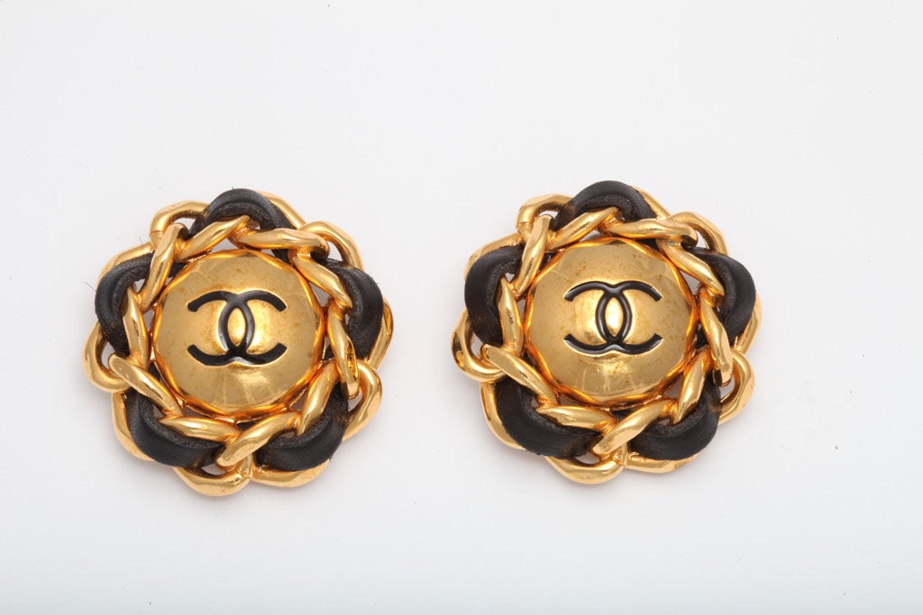 Chanel clip-on earrings with black and gold chain motif and CC motifs.