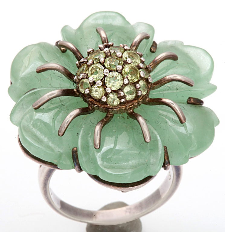 Warning, do beware of bees as this flower is attractive to all species.  Jade petals, are lush and smoothly rounded to curve outward in a strong and supportive silver setting.  Central rests a  nest of peridot stones, faceted for ultimate sparkle. 
