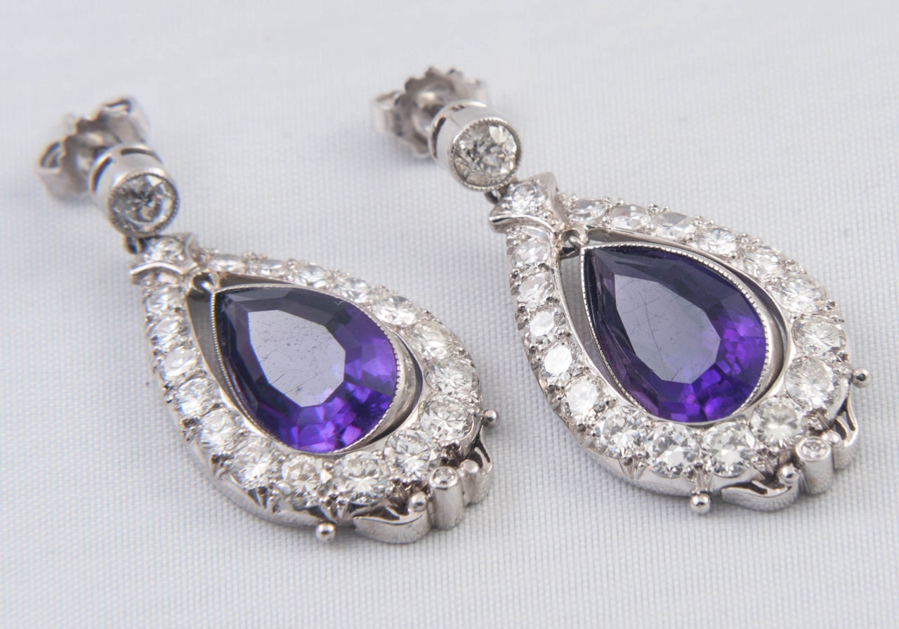 Drop Edwardian Earrings with pear shaped Amethysts to centre. Set in Platinum with post and butterfly fittings