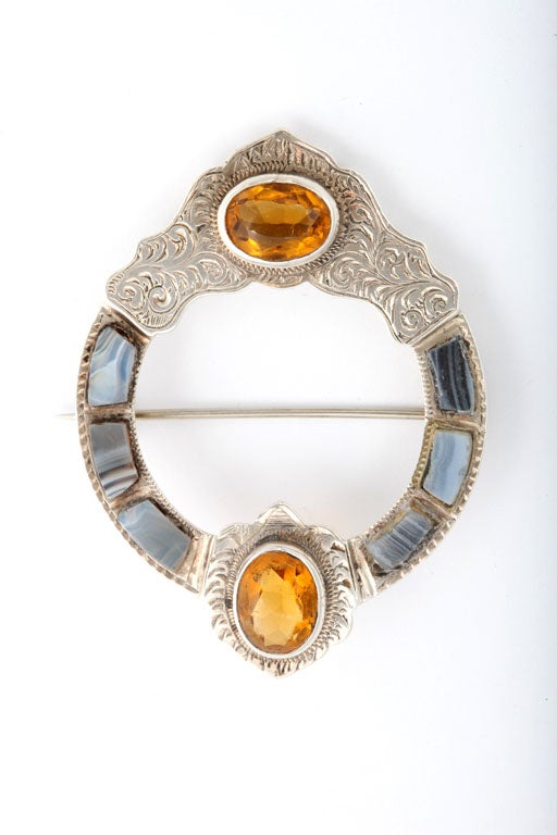 Victorian, sterling silver-mounted (unmarked, but tested), Scottish agate brooch, Scotland, Ca. 1880's. Sterling is beautifully etched. Inset with gray agates and two 