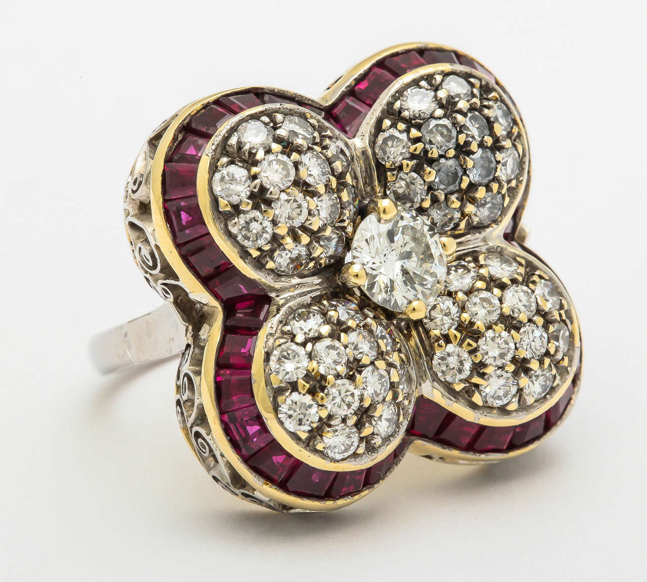 18 KT Gold & Platinum 4 Leaf Clover Floral Cocktail Ring Consisting of 1 Center Diamond weighing .50 Carat and Numerous Old Cut Diamonds Weighing Approximately 1 Carat Further Embellished with Custom Cut Calibre Cut Burmese Rubies Weighing