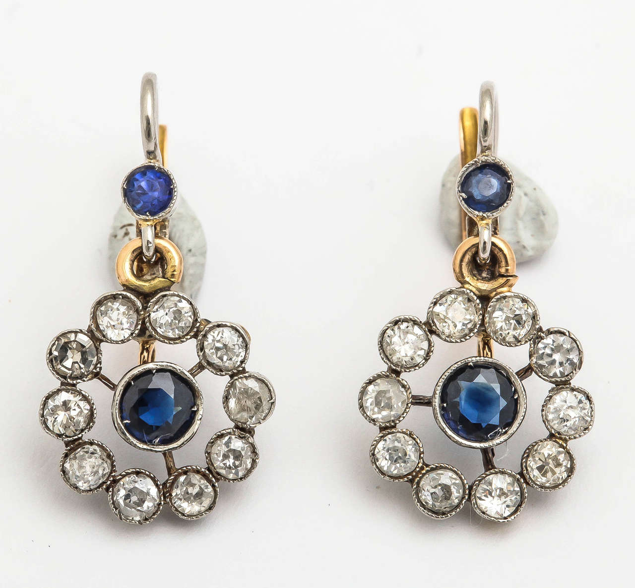 Platinum 18 KT Delicate Gold Floral Earrings Consisting of 20 Old Mine Cut Diamonds Weighing Approximately 1.1 Carat and Further Embellished with 4 Faceted Blue Sapphires Weighing Approximately .75 Carat
Designed with Beautiful French Lever