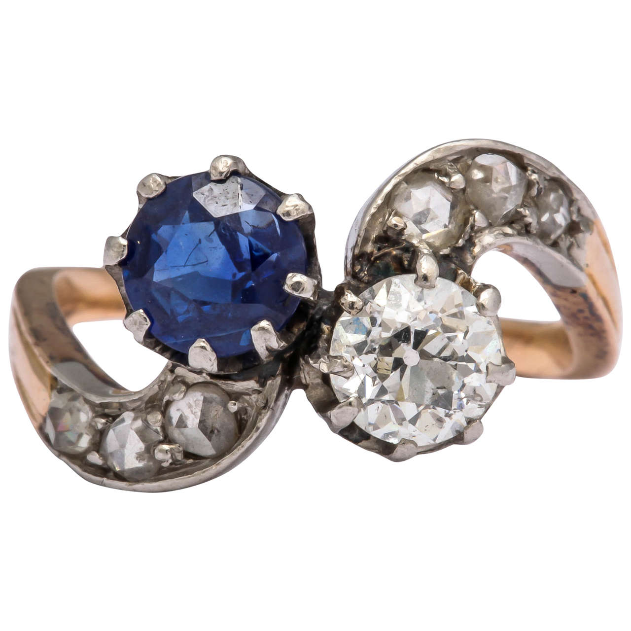 Set with an old European-cut diamond and circular cut sapphire, the curved shoulders with rose-cut diamonds mounted in silver and 18k gold. The ring dates from the late 19th century and is typical of French design.

Size 5 1/2.