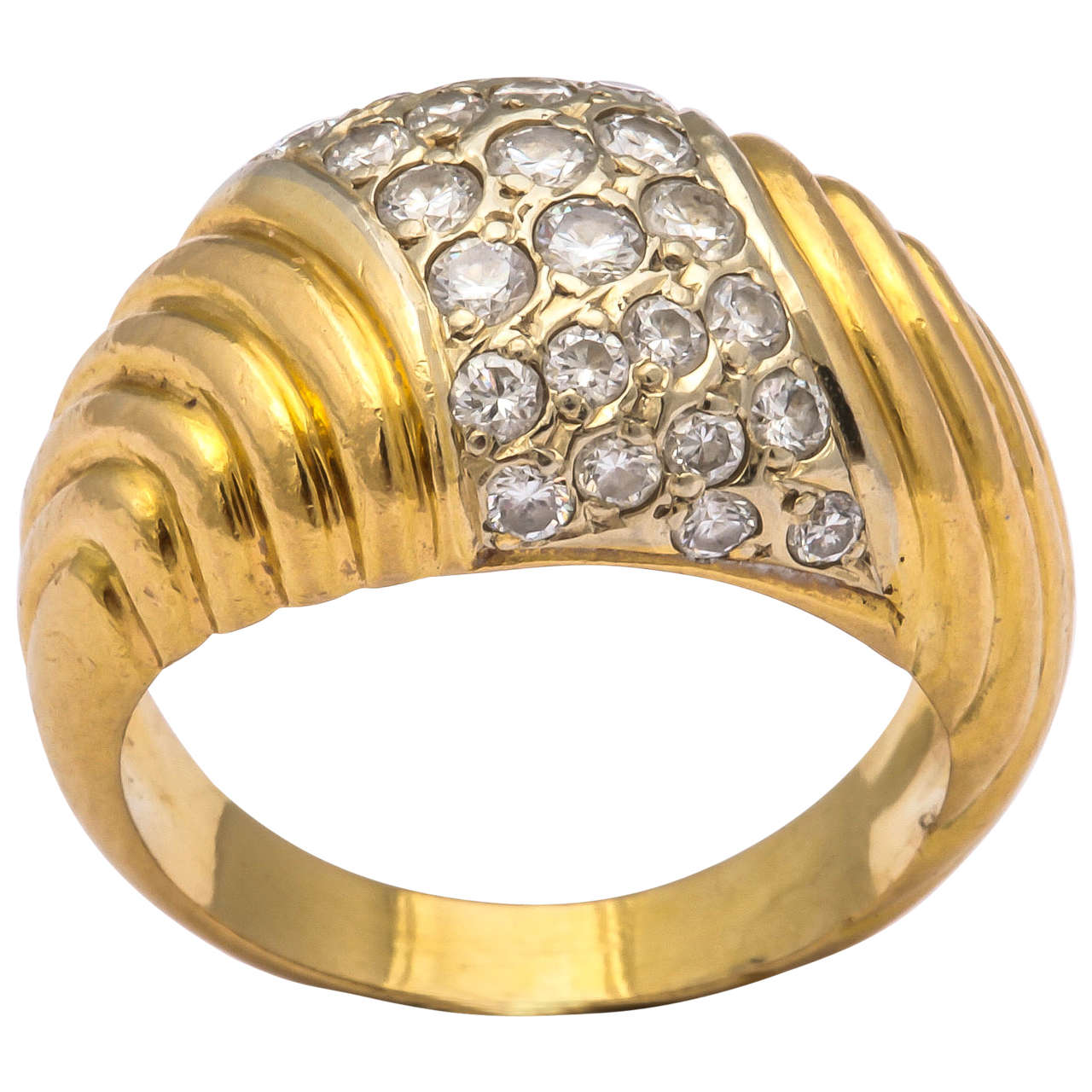 An elegant French 18k gold dome ring, of tapered ribbed design, the center pavé set with diamonds 28 bright white diamonds 

Paris, 20th century, hallmarked with maker's stamp.

Size 4 3/4.