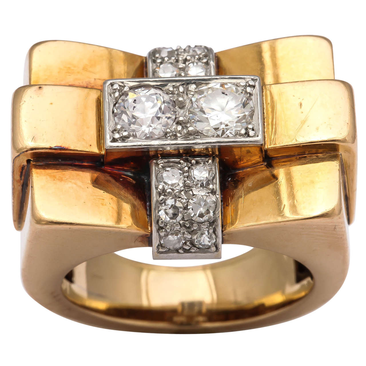 Of angular design, this bague pont or bridge ring from the 40s is set with two central diamonds flanked by six small diamonds on each side forming a cruciform, in platinum and 18k gold. 

French, 1940s, with French control mark

Size 6 1/4. Top