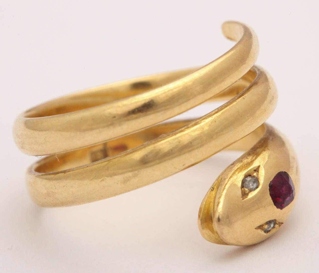  Greetings to a cheerful example of a serpent ring that appears to be smiling enjoying the world in 18 kt gold with diamond eyes and a ruby on the forehead. Why not, she ( my choice of gender) is a symbol of eternal bond and affection.  The serpent