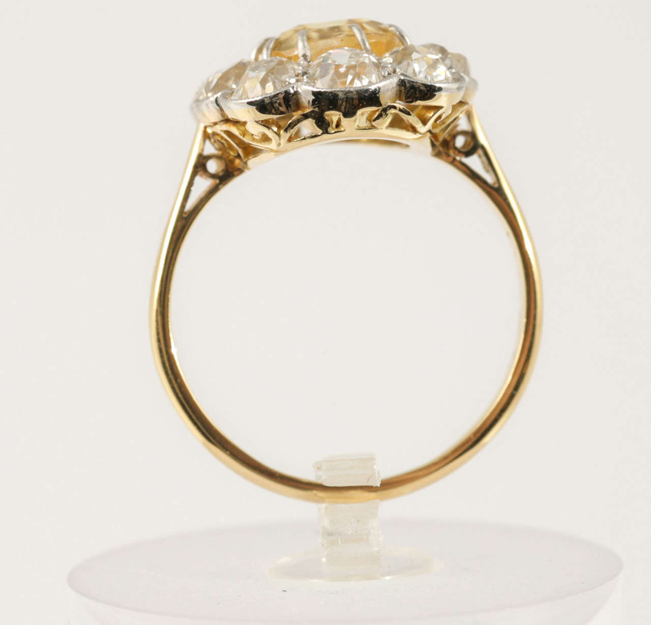 Natural Yellow Sapphire surrounded by 10 old cut Diamonds set in Platinum and 18kt yellow Gold. US finger size 8.5.