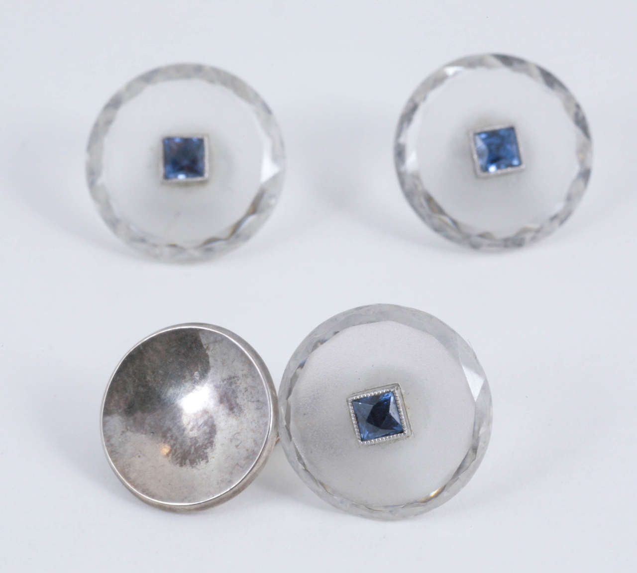 Set Of Early 20th Century Crystal Cufflinks, Buttons, And Studs, With Facetted Border And Centre Square Cut Sapphire. Mounted In Gold.