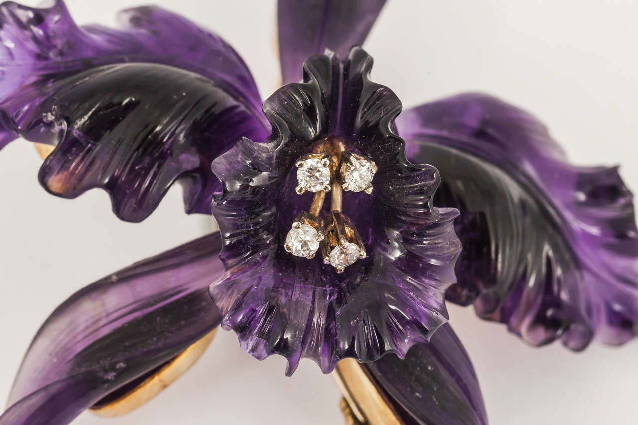 A gold mounted large Amethyst flower brooch in the form of an Orchid carved from one stone, with brilliant cut diamond stamens. Austrian c , 1950