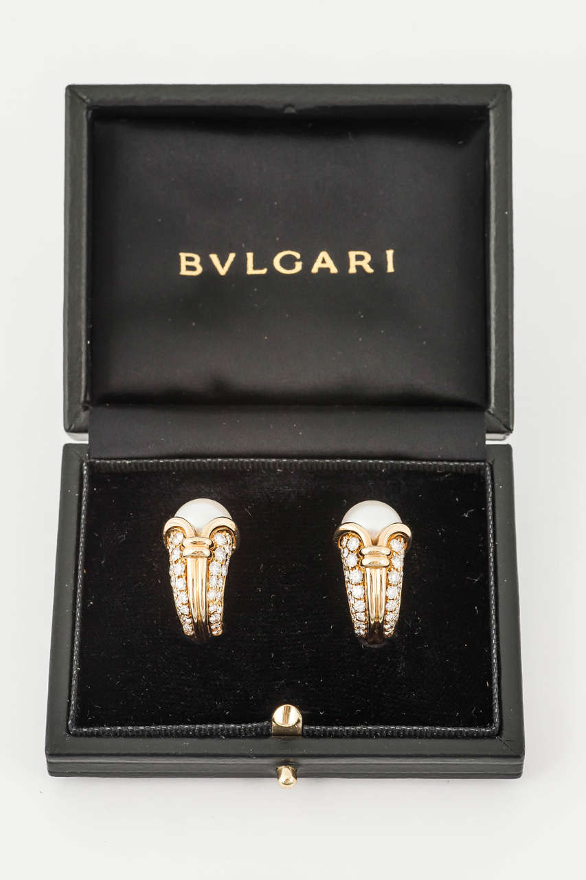 A fine quality pair of cornucopia shaped 18 ct gold clip earrings with pave set brilliant cut diamonds and a cultured pearl. Signed Bulgari in original fitted case