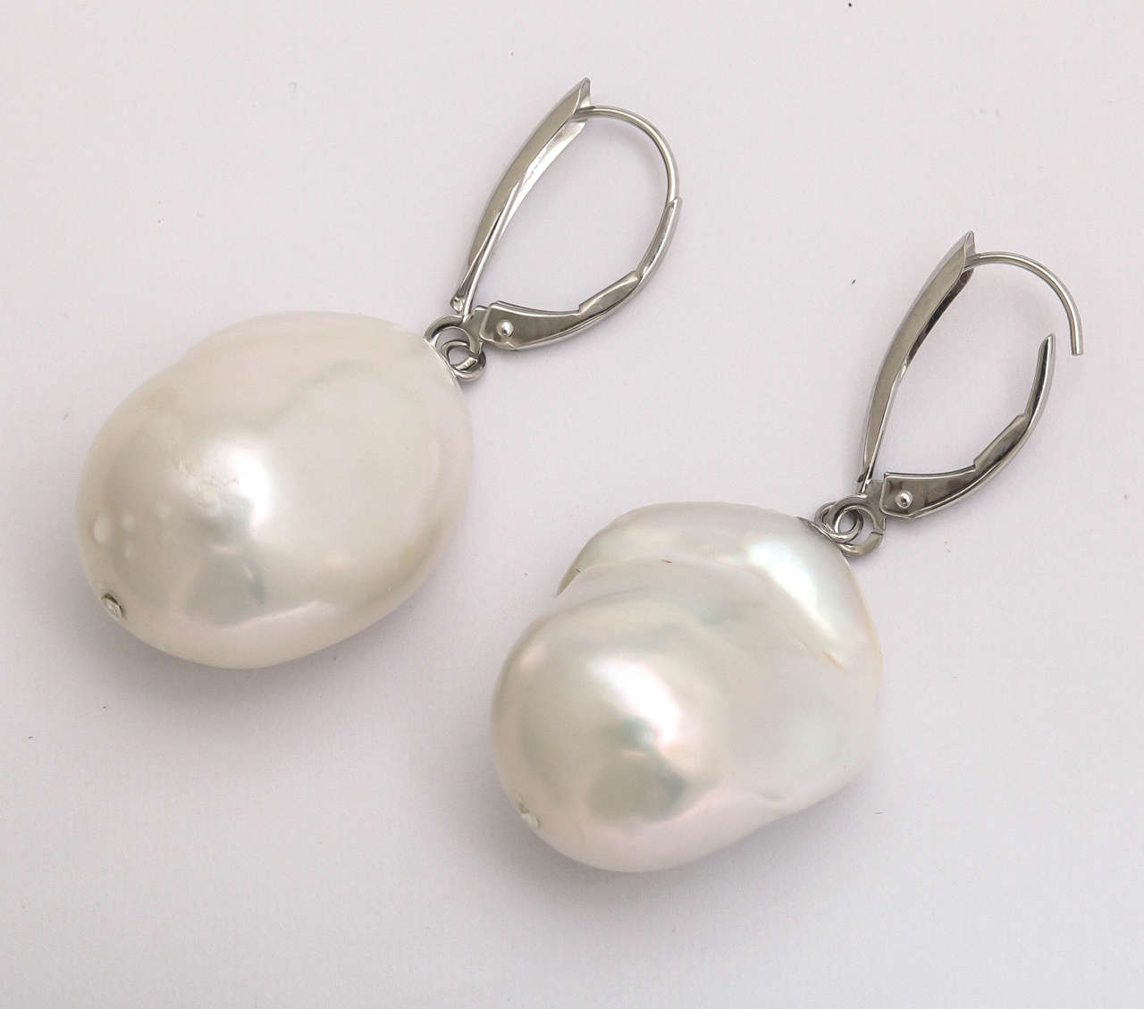 Top quality fresh water baroque pearls dangle gracefully from 14 kt white gold eurowires. The gold section is 3/4 in. long and the total length of the earrings is 1 3/4 in. long. The wonderful lusture is very complimentary next to a woman's skin and