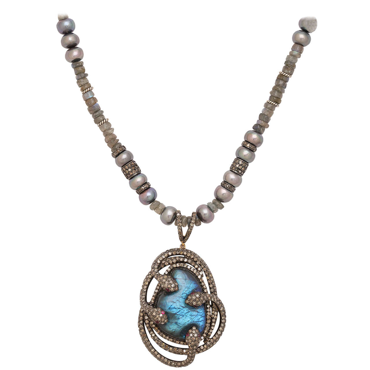 Beautifully designed diamond and labradorite pendant with 4 interlocking snakes.
The exotic piece hangs from a labradorite bead, silver, and gray fresh water pearls. The rondeles on the necklace are silver and rose cut diamonds. Total diamond weight