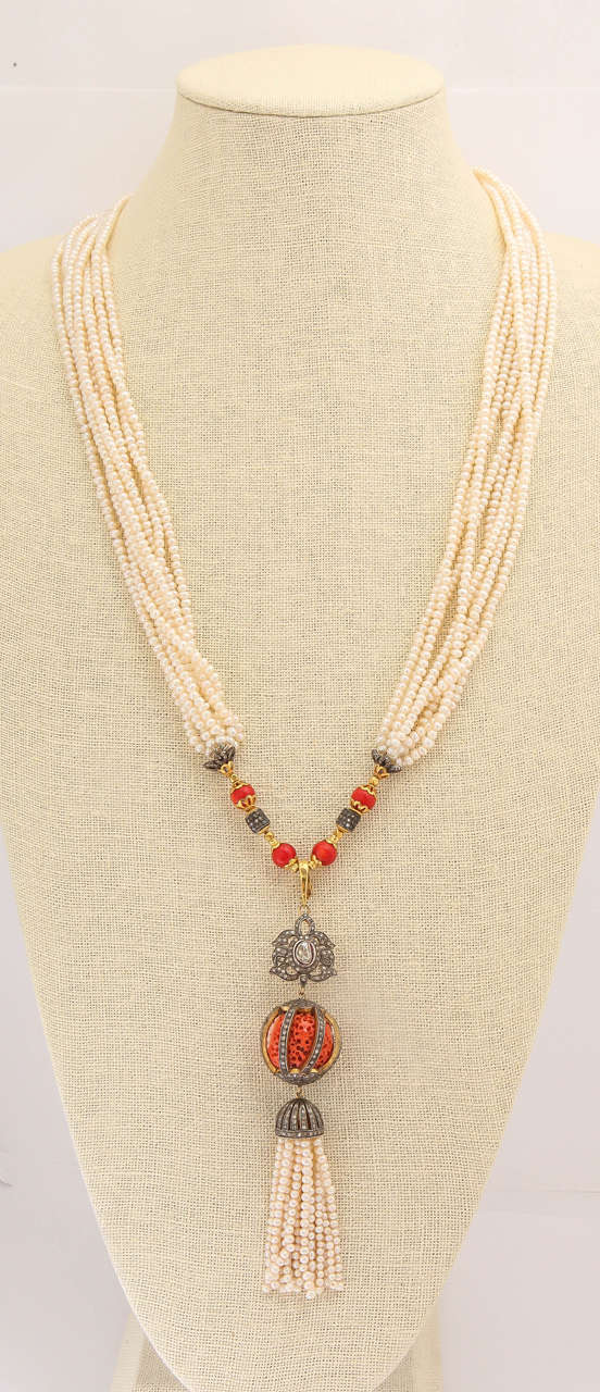 This necklace is beyond description. The 3 section removable tassel pendant contains 2.94 cts diamonds, a 33 ct. natural sponge coral ball and a pearl and diamond tassel. The necklace is 36 inches of  fresh water pearls, coral, 18 kt beads and