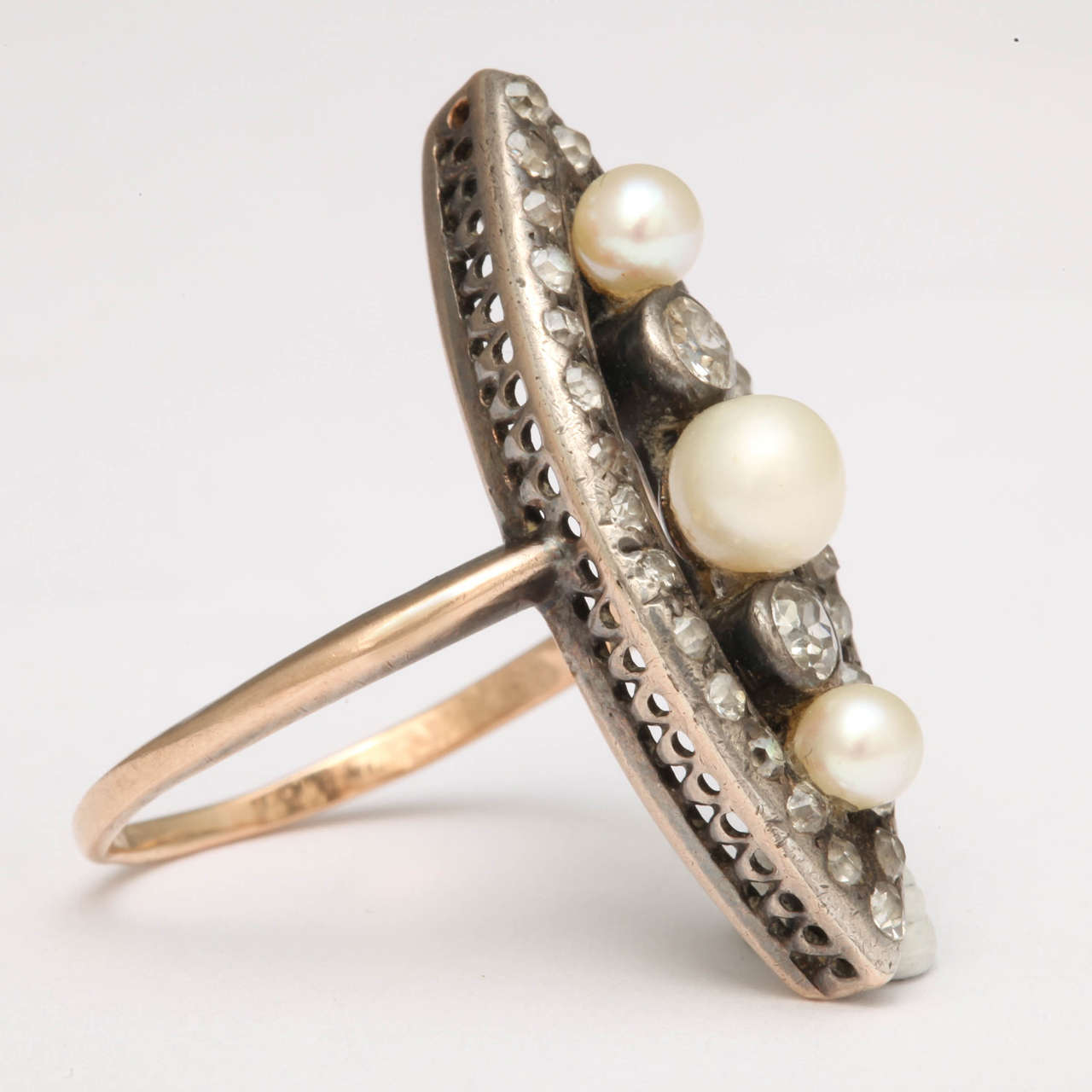 Lovely Edwardian and Marquise shaped ring set with three Natural Pearls & set with old mine Diamonds.  Gold shank & silver top.