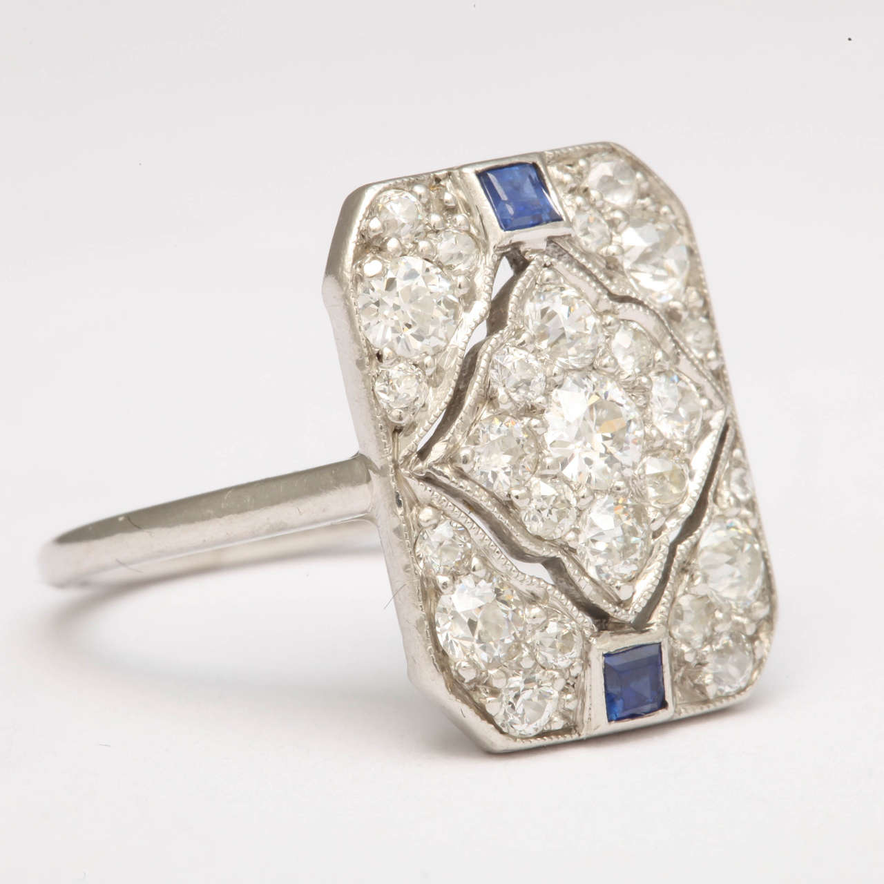 Superb Art Deco Ladies Dinner Ring set with center Diamond Tapestry & 4 Diamond Corners.  Sapphire Accents.  Set in  14kt White Gold. Number but not signed