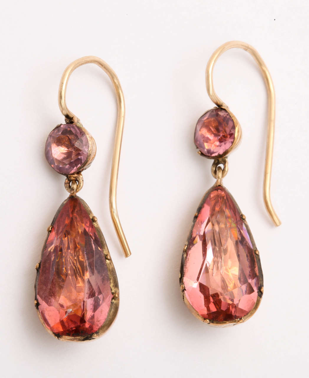 Set in 15kt gold, these Georgian era saturated pink paste stones are faceted beautifully and foiled to perfection.  By the early 19th century the art of foiling paste and gemstones was well advanced and had shined in many nations of the world.