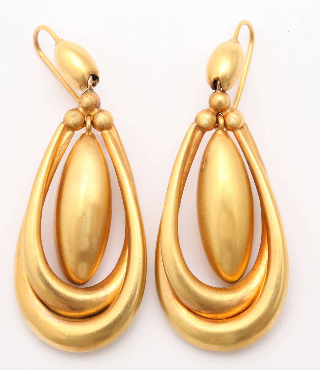 Golden Earrings of  15kt are always elegant, always wearable and always lighten the features. In this pair, the outer double hoops float a sizable center oval that hangs freely and will move with your movement  when you declare yay or nay, bringing