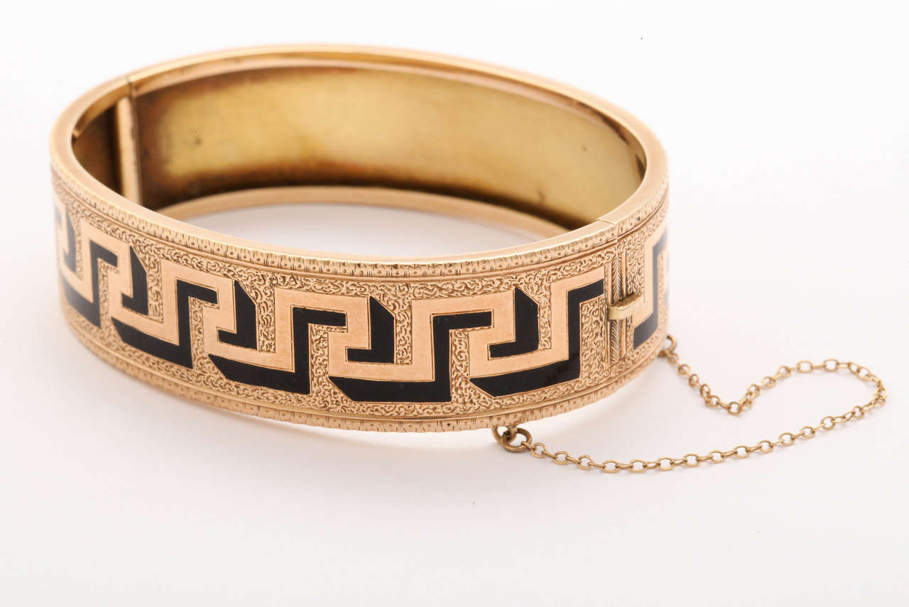 A strong three dimensional Greek Key pattern appears to rise from the fine background engraving on our 14 kt Victorian bangle that maintains its perfect condition. The bold design,  winds around the perimeter, and makes a graphic statement in