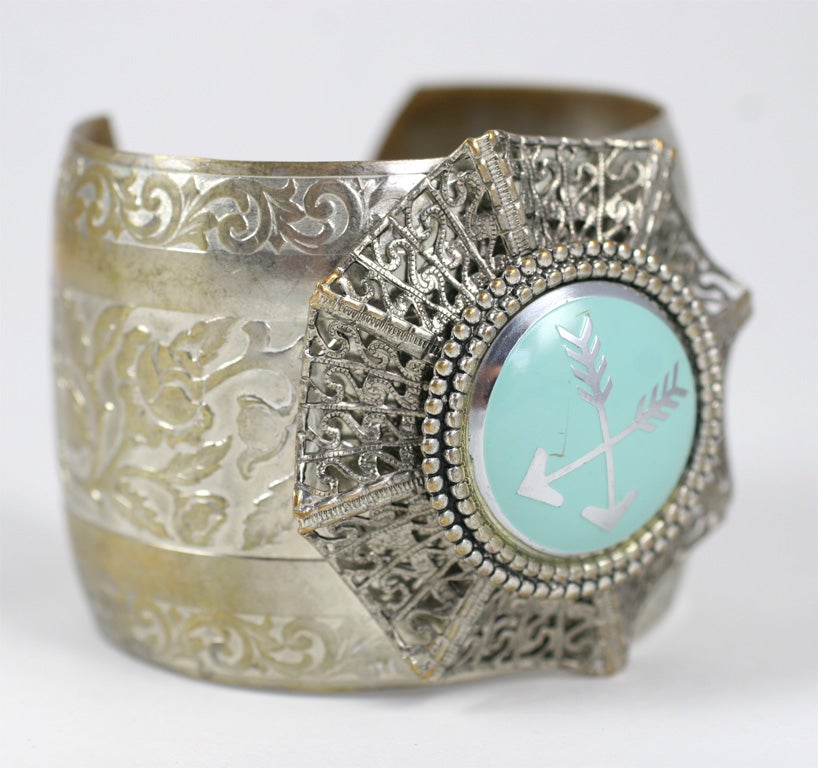 Wide silvertone cuff with large decorative enamel medallion with matching oval screw back earrings.  Earrings are 1.13