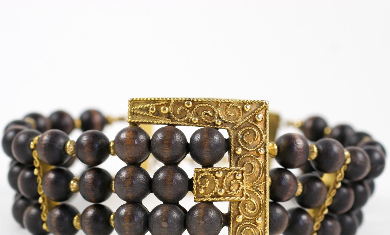Chic 60's large goldtone buckle design wood bead choker. Adjusts from 11.75