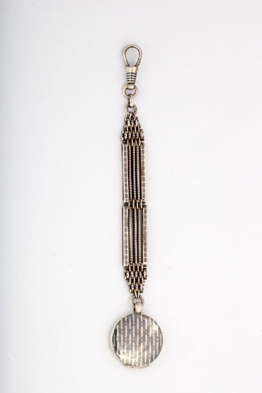 Detailed geometric design was worked into every millemeter and on both sides of this antique watch fob. Niello took hand, patience and work. Silver is incised in miniscule patterns according to design, and black alloy iis added to fill the