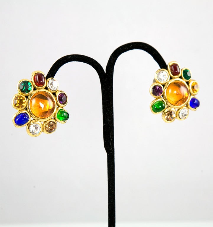 Beautiful pair of clip on earrings by Chanel featuring a cluster of bezel set multi-colored glass and rhinestones.  Stamped and marked Chanel made in france.