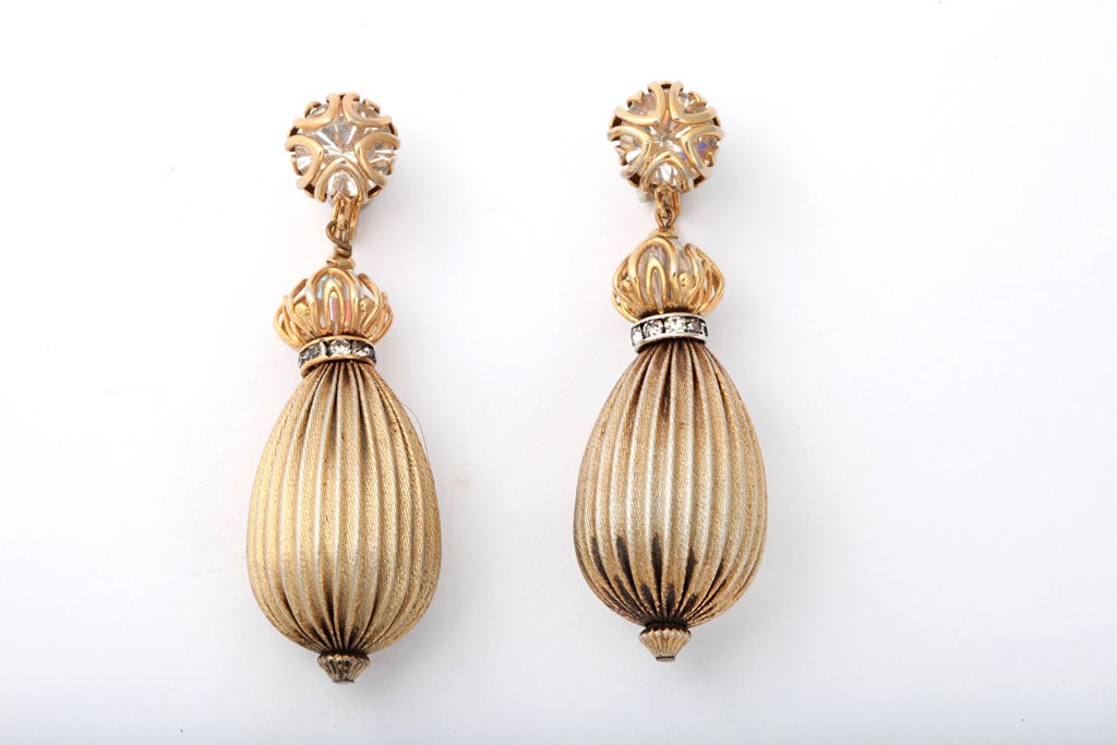Goldtone metal and rhinestone teardrop shaped earrings.
