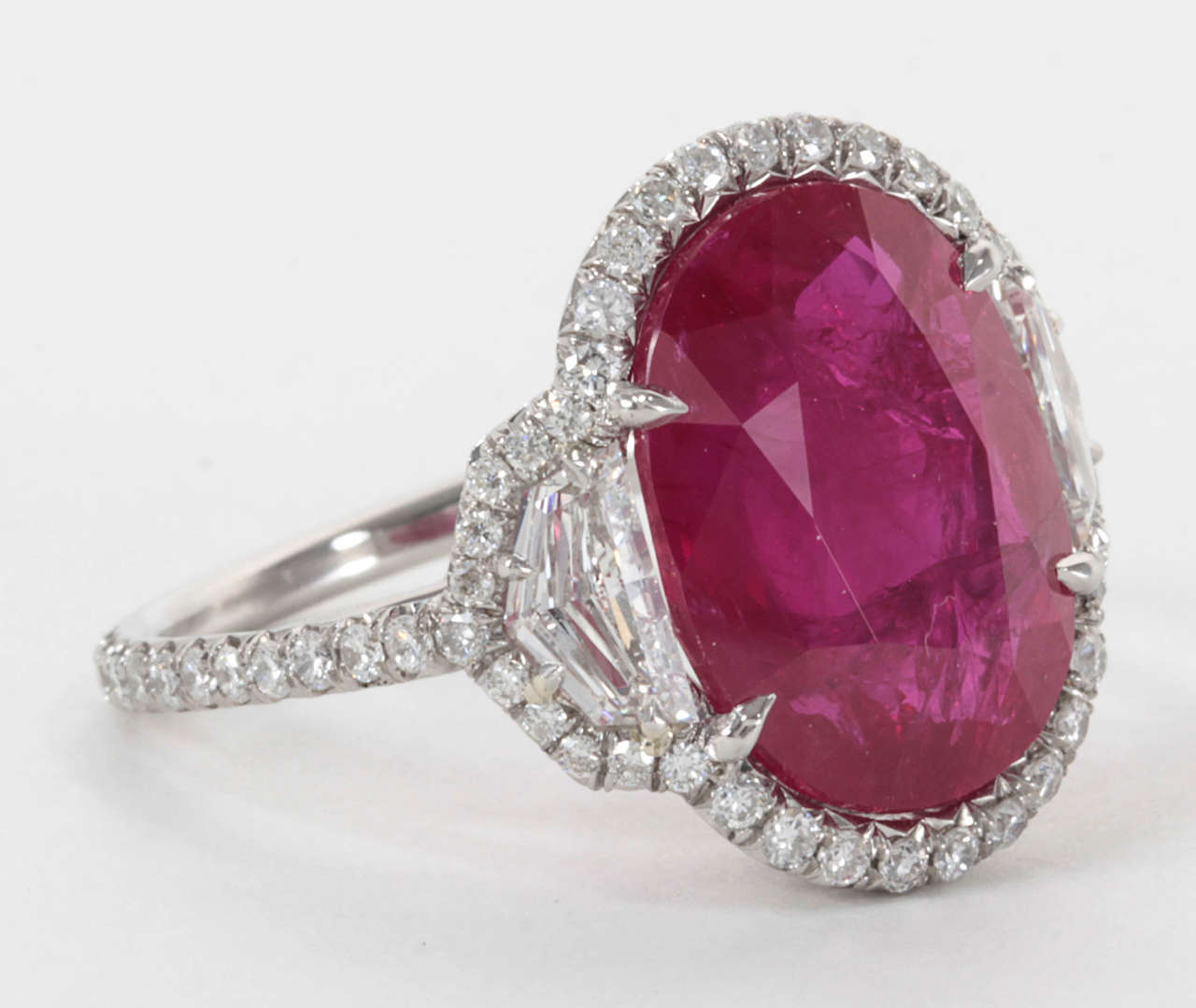 Beautiful oval 8.06 carat ruby set in a handmade micro pave diamond mounting with special cut side diamonds.

1.56 carats of diamonds set in platinum.

Pictures do not do this ring justice, please contact us for more information. 