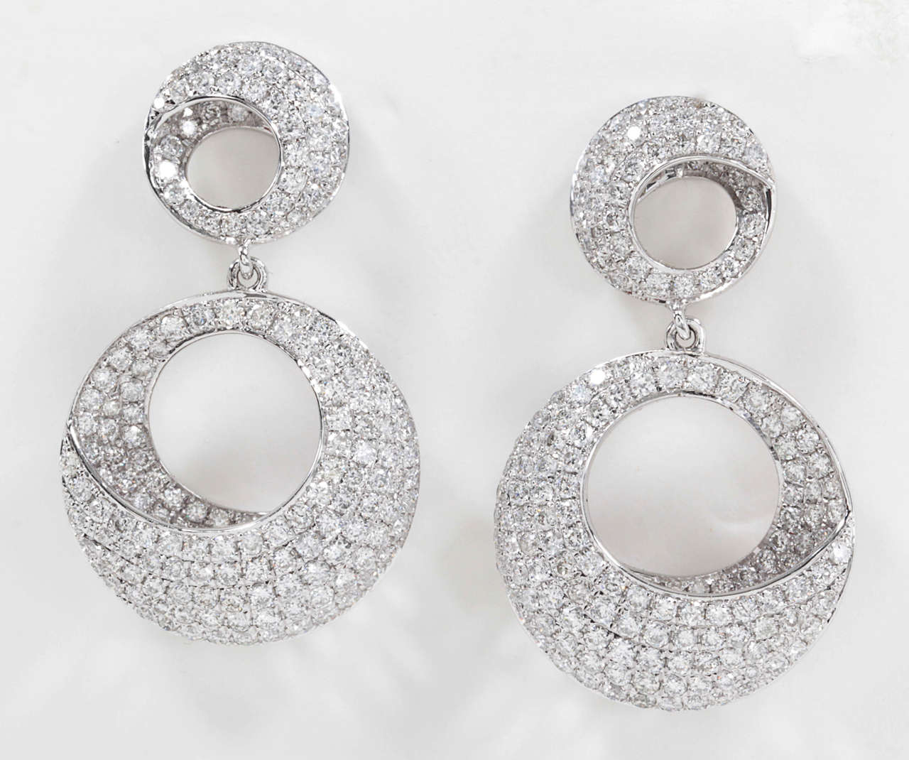 A beautiful design! 

2.86 carats of white round brilliant cut diamonds set in 18k white gold.

You will get a lot of use out of these earrings.