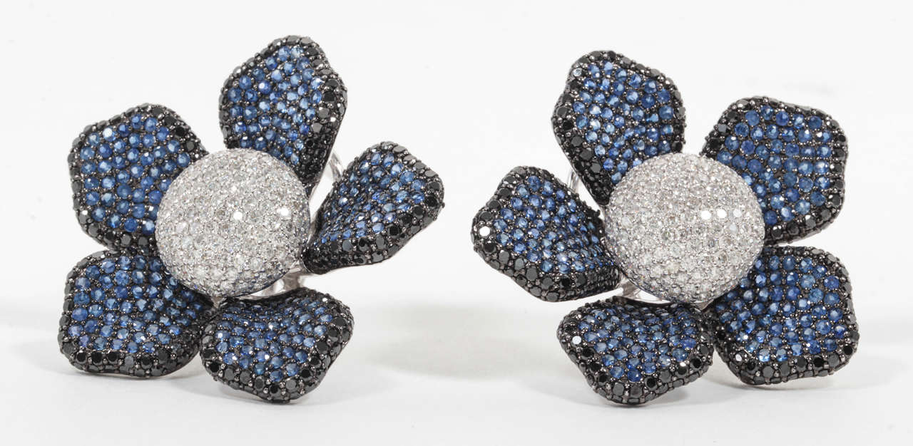 Large Diamond and Sapphire Flower Ear Clips for pierced ears.

7.43 carats of diamonds, 5.65 carats of blue sapphire set in 18k gold.

The center of the earring is made up of white diamonds and the flower petals are made up of blue sapphires
