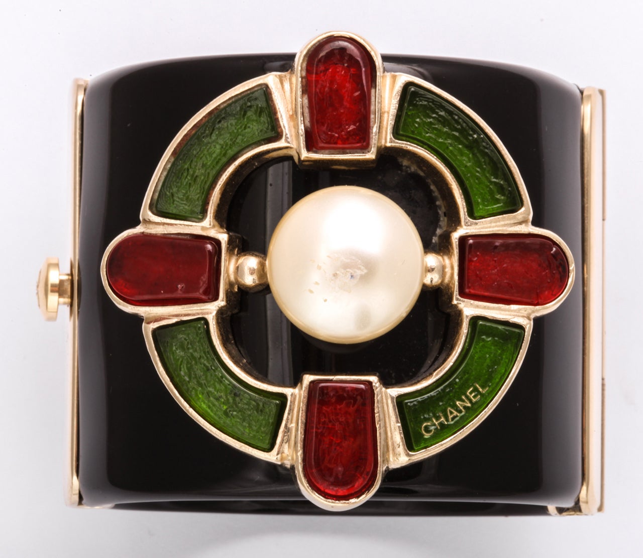 A great signed  Chanel resin cuff with red and green poured glass decoration surround a pearl.