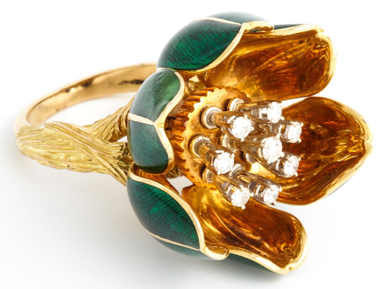 Modelled as a flower with articulated green guilloché enamel folding petals. The centre set with articulated claw-set diamond eight stone stamens, the shank of the ring is modeled as intertwined branches. Ring size 51 ½