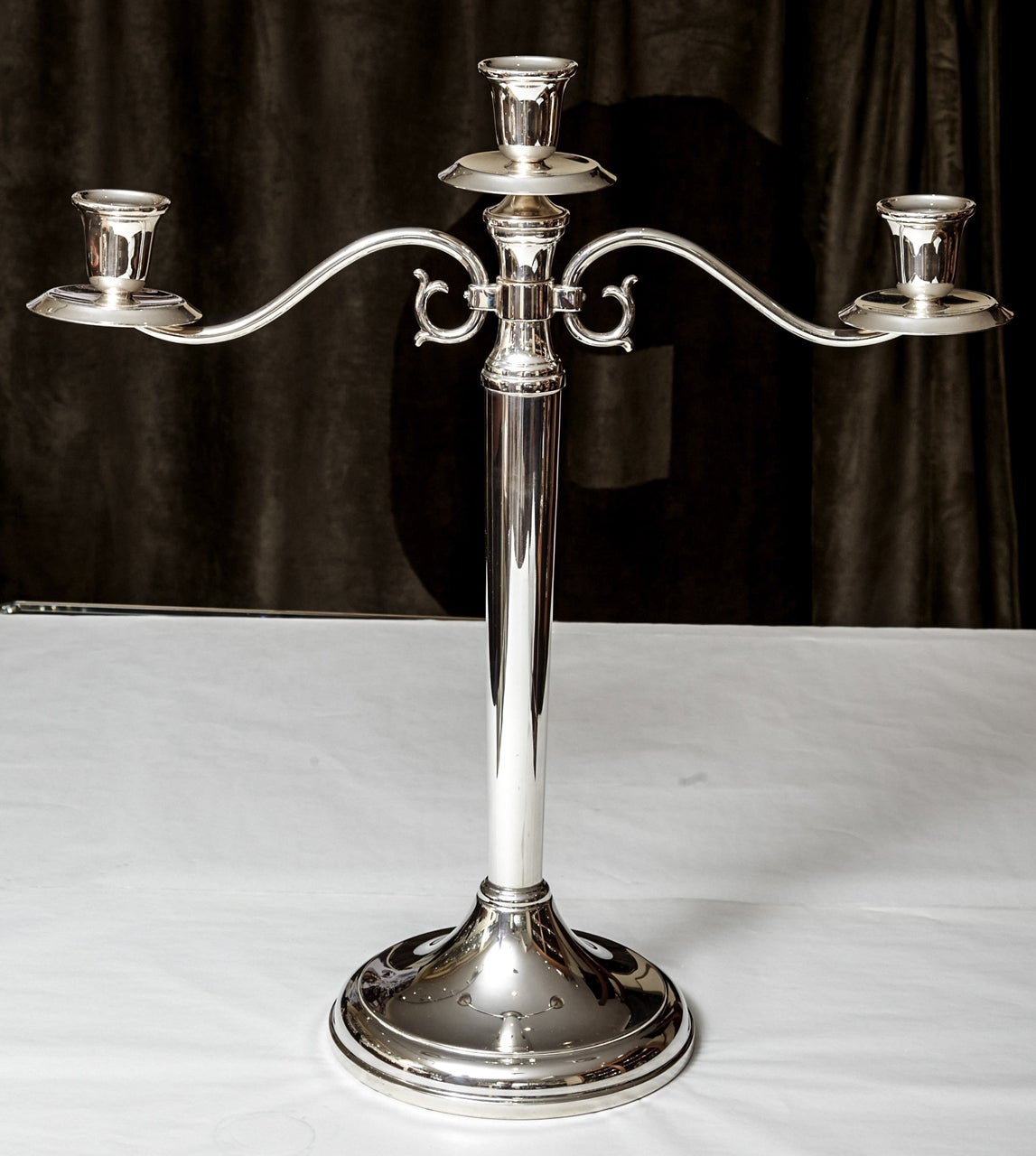 A handmade silver three arms candelabra