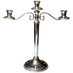 A handmade silver three arms candelabra