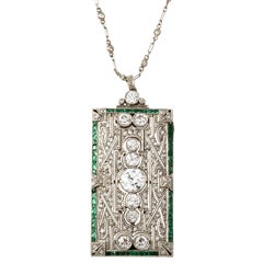 An Art Deco platinum emerald diamond brooche/pendant