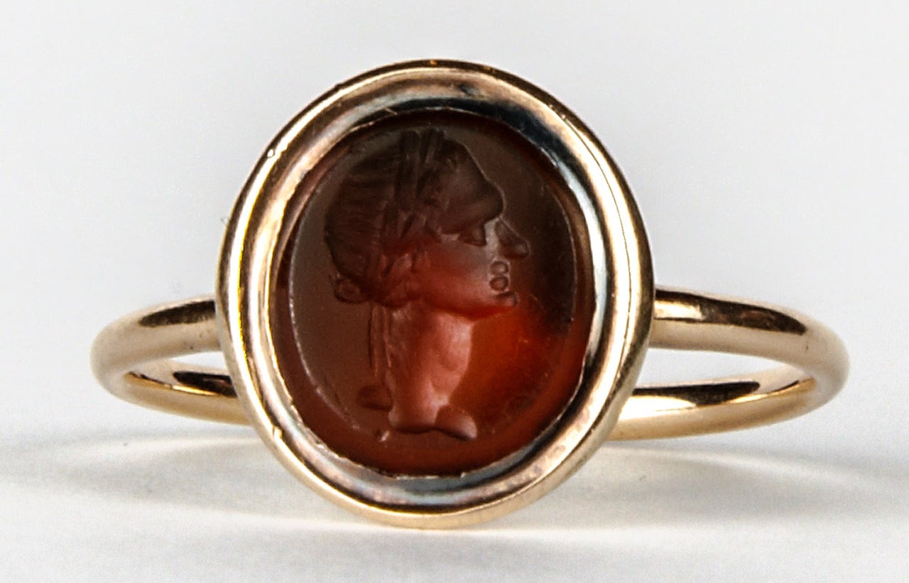 Thin 18K pink gold ring set with an antique carnelian intaglio depicting the profile of Caesar.
The intaglio is 18th century and its mounting slightly later (mid 19th century).  
The ring's head is 0.4 inch high and its size is metric 46/US 4