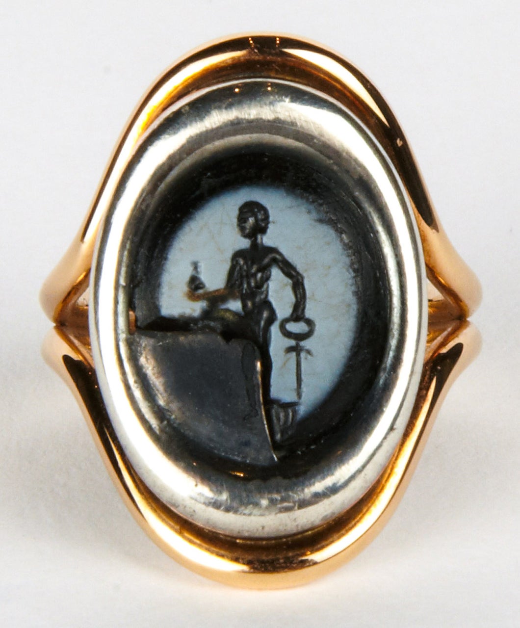 Ring in silver (3.8 grams) and 18K pink gold (6.4 grams)  set with a 1st century Roman nicolo agate intaglio depicting Mercury, carrying his purse and holding his caduceus, the quarter lacuna filled with oxidized silver.   
The ring head is 1 inch