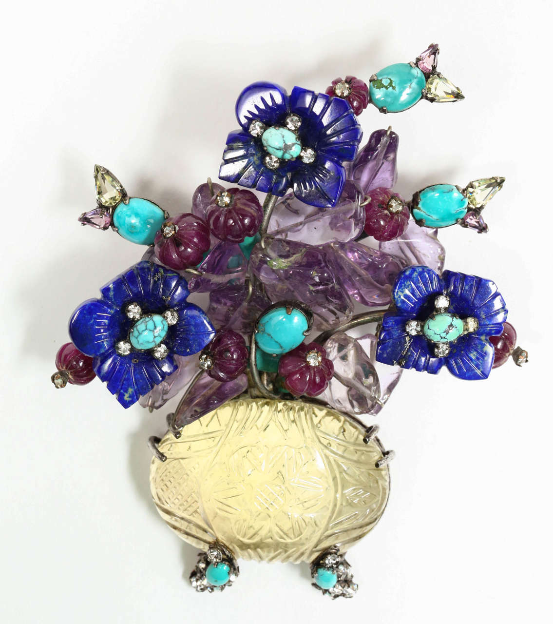 A beautiful and colorful brooch of a vase of flowers by Iradj Moini. The pin is composed of lapis, turquoise, ruby, amethyst, citrine and rhinestones and is marked on the back with the Iradj Moini plaque (see Image 6).