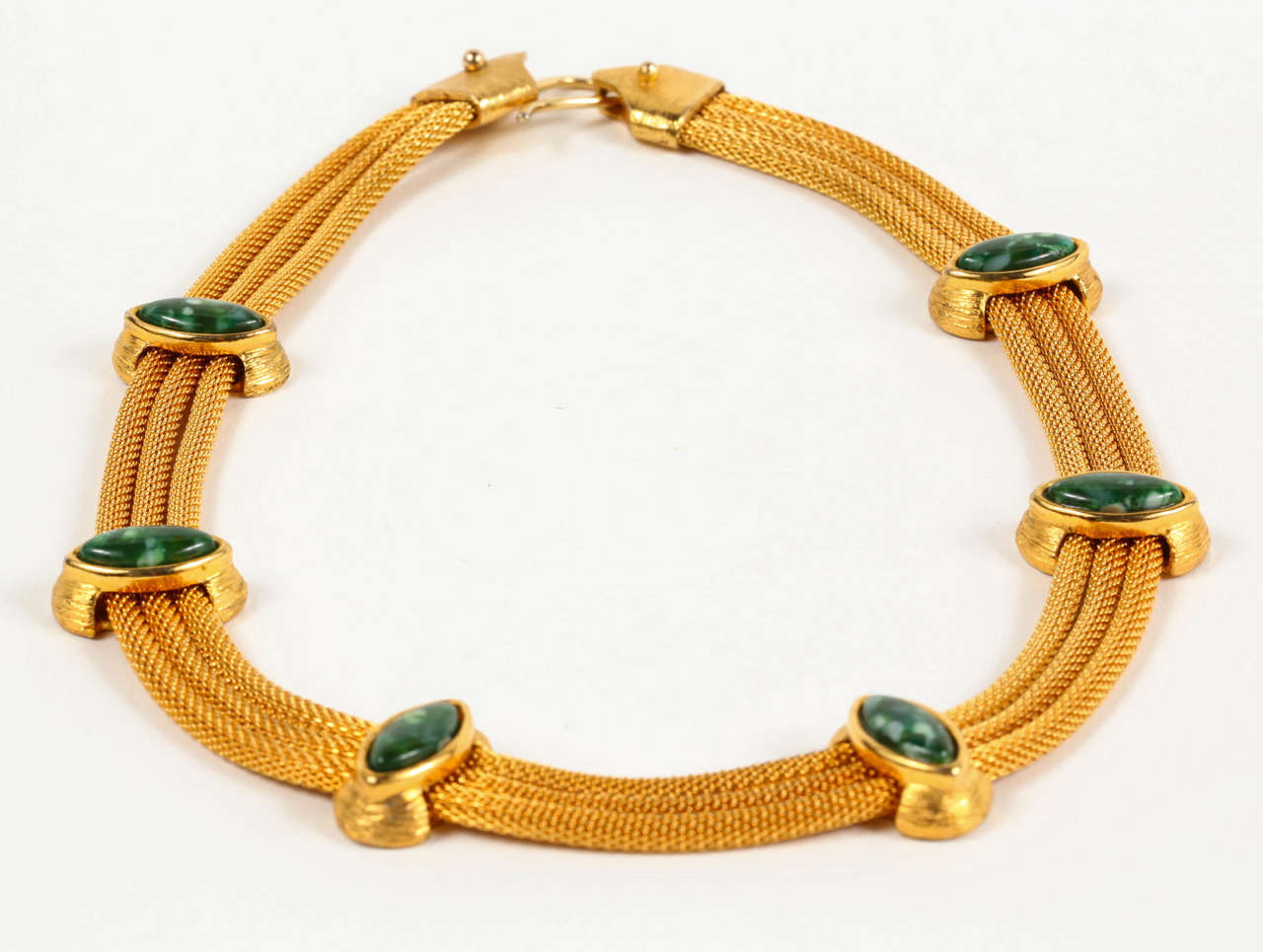 A stylish short necklace, by Ron Rizzo, of a triple mesh strand punctuated by mottled green stone marquise cabochons with strie detailing on their settings. Stamped at the clasp 