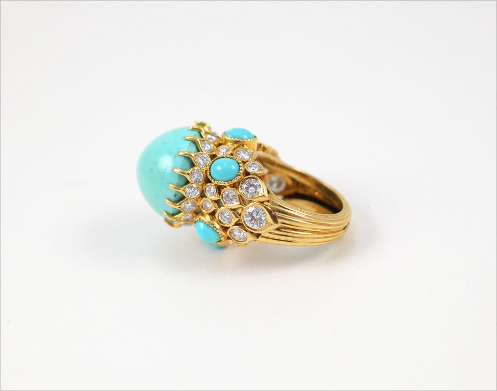 A unique Cocktail Ring with a center domed Turquoise set in a mounting with turquoise and Diamonds. With 45 brilliant cut Damonds  weighing approximately 5.20 Carats
