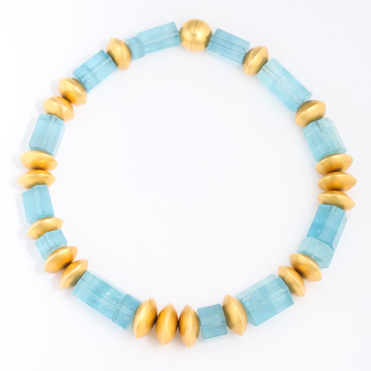 Hexagonal Aquamarine Beads separated by flattened round beads in 18kt Yellow Gold Beads.  Bold & giving the air of an Ancient Collar.  The closing is an 18kt Circular Bead with an invisible closing .