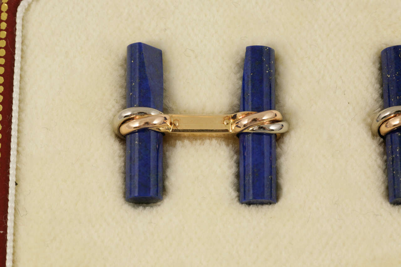 Cartier set of two colour gold crossover baton cufflinks with lapis lazuli,crystal, malachite and bog oak,in fitted Cartier case.