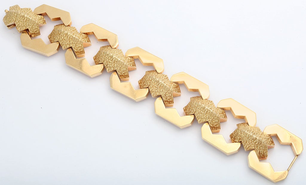 A rare 18kt articulated retro machine age style linked bracelet. The angular medalions are connected with 'nugget' links and is signed by a European designer along with the Tiffany and Co mark. 90 dwt